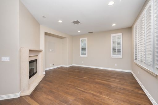 A spacious room with hardwood floors and windows with white blinds. California, USA