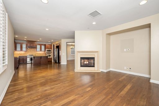 A spacious room with hardwood floors and a fireplace. California, USA
