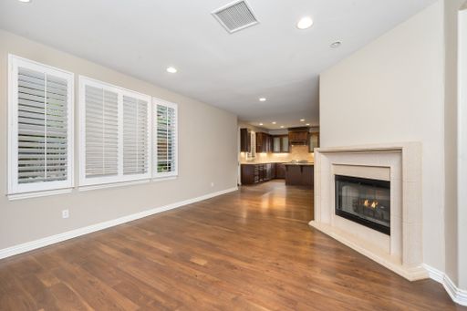 A spacious room with hardwood floors and a fireplace. California, USA