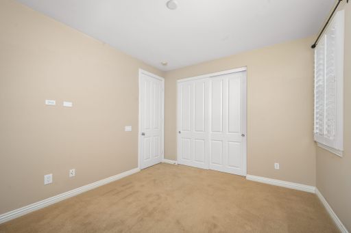 An empty room with tan walls and white doors. California, USA