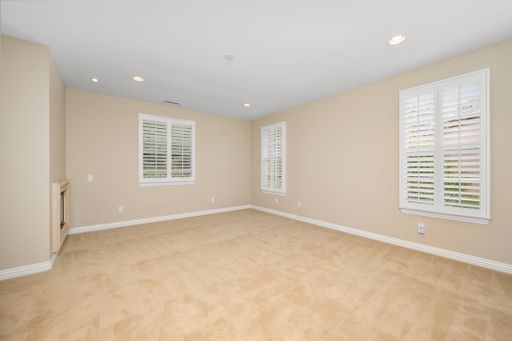 An empty room with tan walls and windows. California, USA