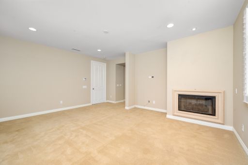 An empty room with tan walls and a fireplace. California, USA