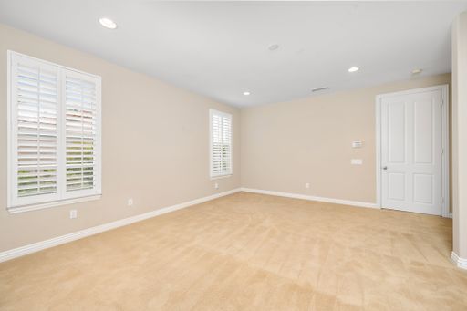 An empty room with tan walls and windows. California, USA