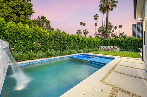 A backyard pool surrounded by lush greenery. California, USA