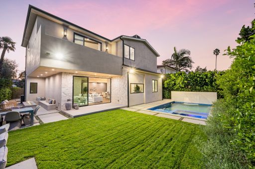 A contemporary house at twilight with a view of the patio and pool. California, USA