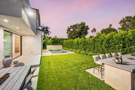A garden with lush green grass and a pool in the backdrop. California, USA