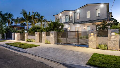 A house with a beautiful garden and metal gates. California, USA