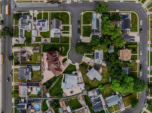 A top-down view over a middle-class residential neighborhood on a cloudy day.