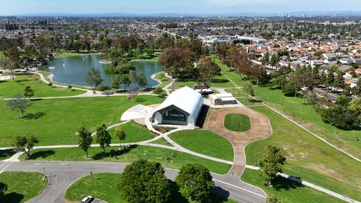 Aerial view of Freedom Hall and lake in Mile Square Regional Park, Fountain Valley, California on a clear day
