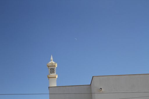 A low angle shot of the facade of an old building under the clear blue sky