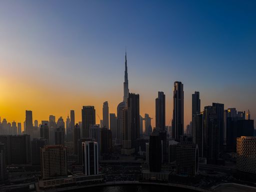 The silhouette of Dubai skyline with Burj Khalifa at sunset, showcasing the city's architecture