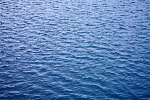 A serene view of rippling blue water surface with gentle waves