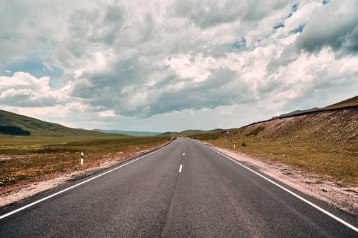 An empty rural road on a cloudy day