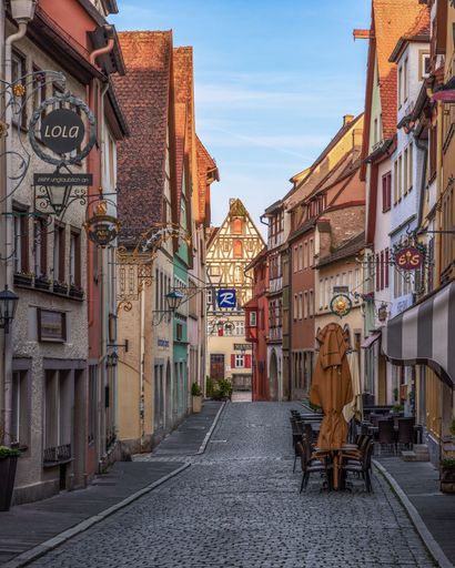 A Beautiful cobblestone street with typical old colorful german buildings in old town of the medieval fairytale Rothenburg ob der Taber
