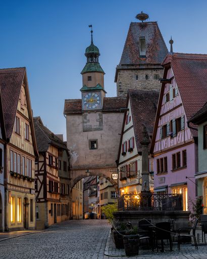 A vertical shot of the Markus Tower (Markusturm) against blue dusk sky at sunset in Rothenburg ob der Tauber town, Bavaria, Germany