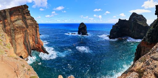 The majestic cliffs with the blue waters on a sunny day in Vereda da Ponta de Sao Lourenco, Madeira, Portugal