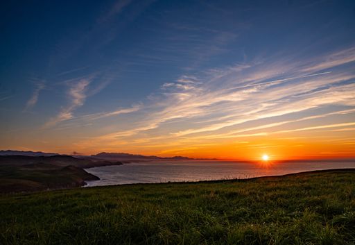 A scenic view of a beautiful sunset over a coastal landscape