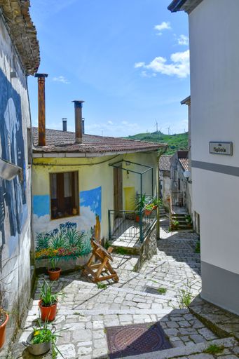 A narrow street between the old houses of a rural village in the province of Avellino.