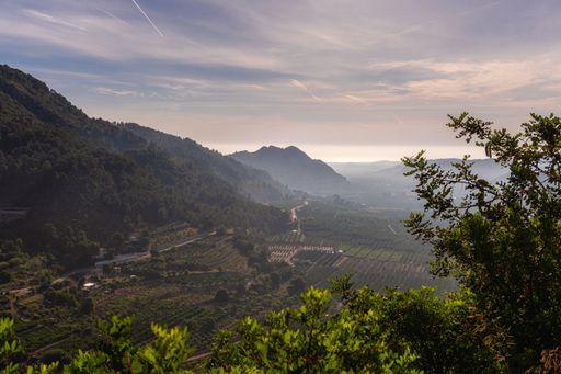 A beautiful aerial shot with cultivated fields and high mountains
