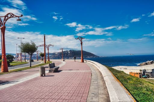 A pathway near the beach under a blue sky in Galicia, Spain