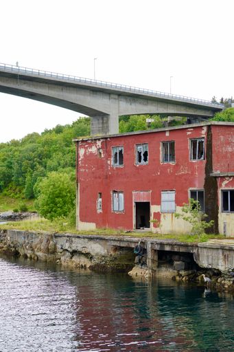 A vertical shot of derelict industrial building on the Nordholmen islet in the port city of Kristiansund, Norway