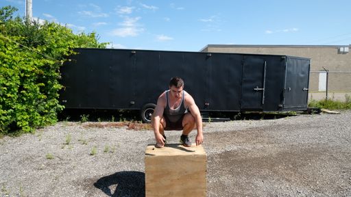 A Canadian sportsman doing box jumps during his outdoors workout