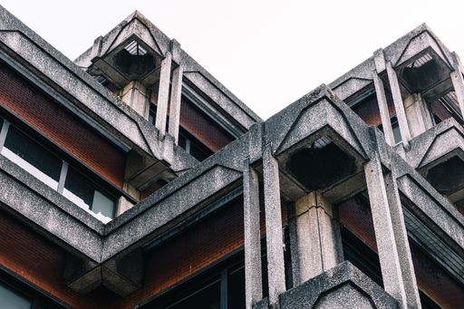 A Close-up of a brutalist architecture building with concrete and brick materials.