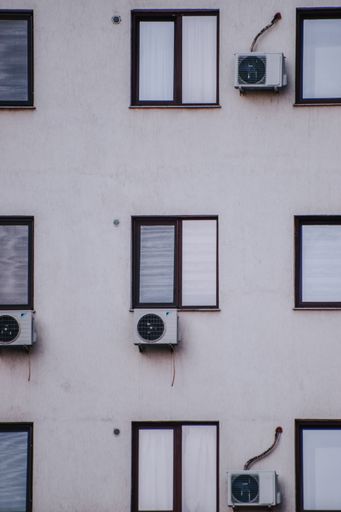 A white building with a lot of air conditioners
