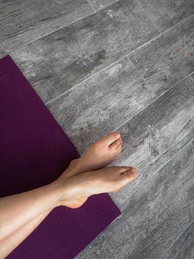 A high angle shot of female feet on a purple mat