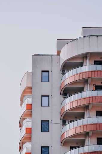 A beautiful view of the front facade of a building with balconies