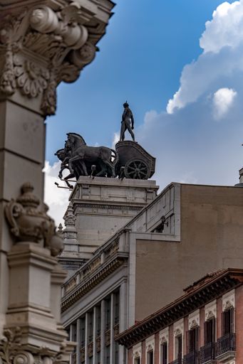 A detailed view of the Quadriga statue atop the Metropolis Building in Madrid, Spain