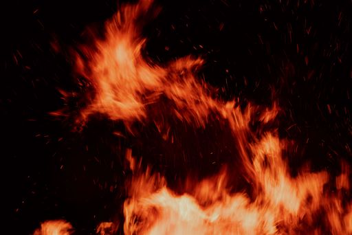 A close-up of fire sparks flying in a dynamic pattern