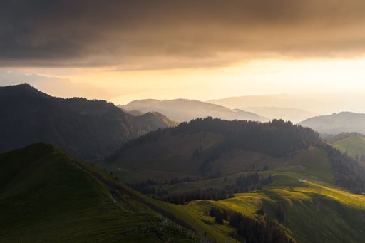 A beautiful spring landscape view of mountain layers and the Geneva lake illuminated by a gorgeous sunset light