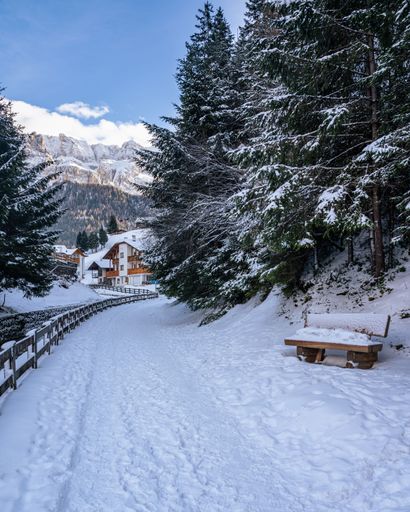 A Snow-covered path in Selva di Val Gardena in winter, Alto-Adige, Italy