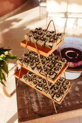A display of assorted chocolates on a wooden stand in a well-lit room