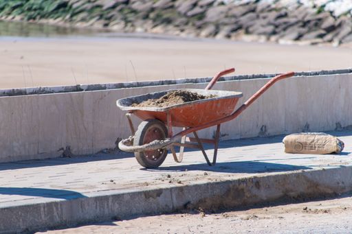 A wheelbarrow filled with sand at a construction site in Essaouira, Marrocco