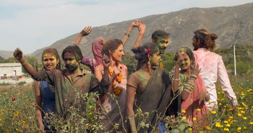 Holi, the Hindu festival of Color from India, being celebrated outdoors by a group of Indian people in traditional costume clothes