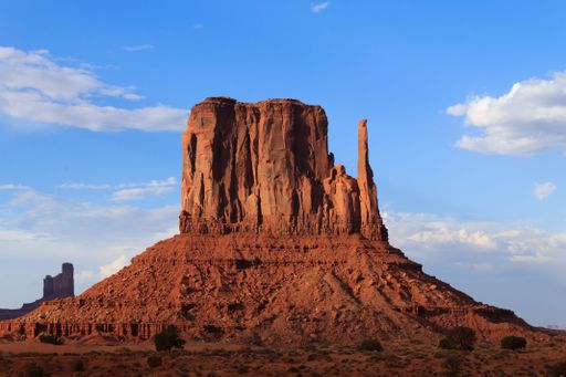 A stunning view of Monument Valley with a clear blue sky and red rock formations.