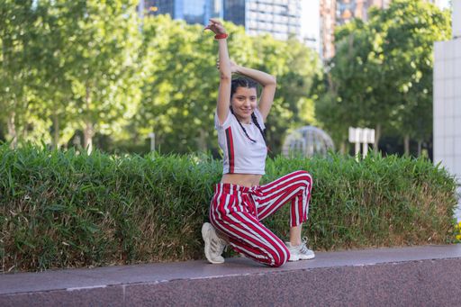young girl performing urban dance with different postures on the street on the street to be fit and have healthy lifestyle habits and have a healthy b
