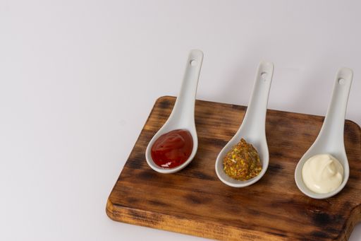 spoons three sauces ketchup mayonnaise mustard white background