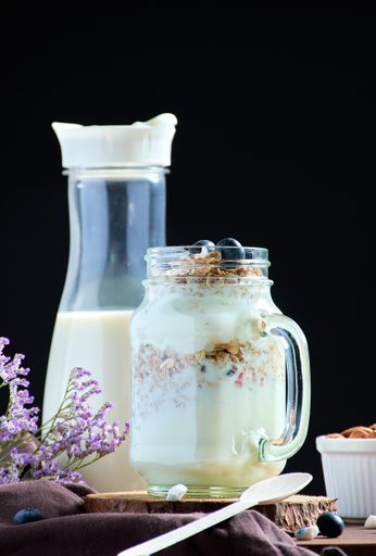 A vertical shot of healthy breakfast with milk and snacks on a decorated table