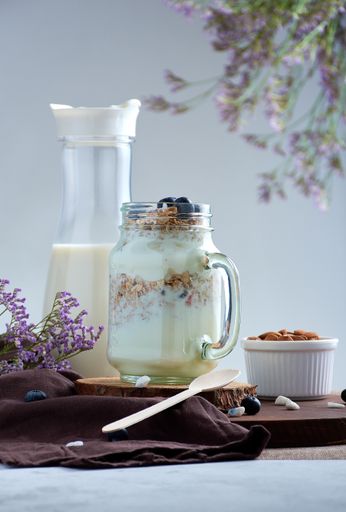 A vertical shot of healthy breakfast with milk and snacks on a decorated table
