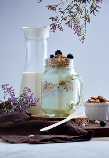 A vertical shot of healthy breakfast with milk and snacks on a decorated table