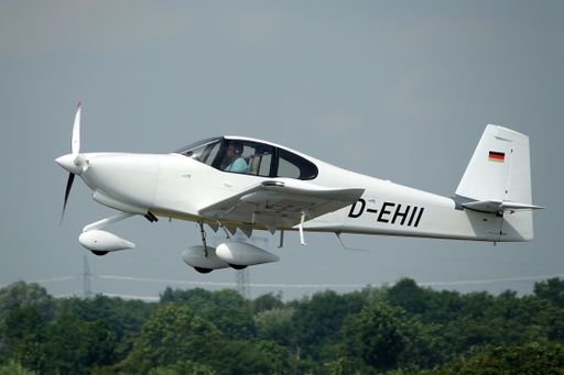 Aerial shot of a German registered white light aircraft after taking off