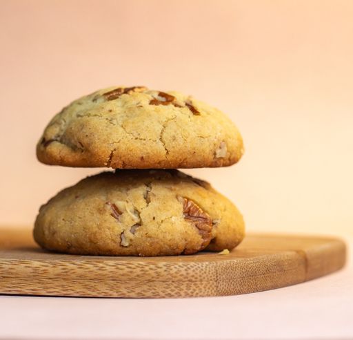A vertical shot of vegan chocolate chip cookies on a wooden board