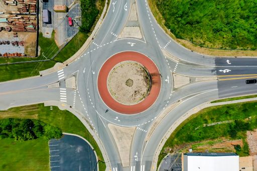 An aerial shot of a roundabout with a red circle in the middle