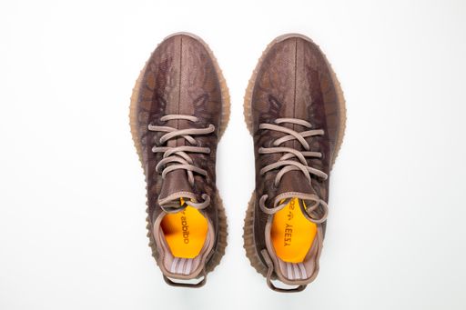 A closeup of Adidas Yeezy boost 350 V2 Mono Mist. Famous limited collection sneakers. Adidas running shoes isolated on a white background.