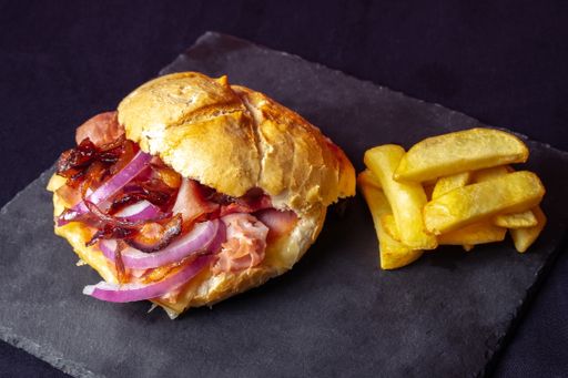 A high-angle shot of a fresh sandwich and french fries on a black background