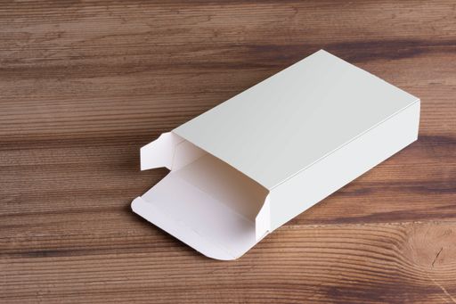 An opened empty pillbox on wooden table background, mock-up series template ready for your design