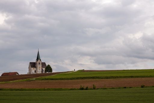 A closeup view of a medieval castle on the far back of a field